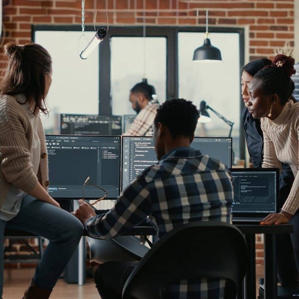 Software programmers discussing about online cloud computing while the rest of the team joins